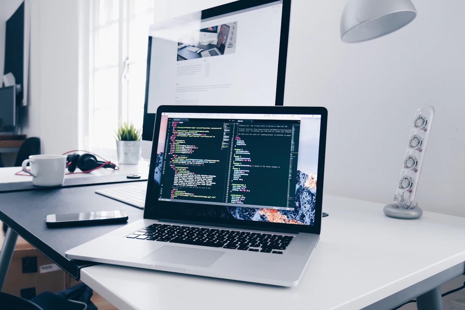 Clean modern workstation with code on screen — Rixsols AI and software engineering craft